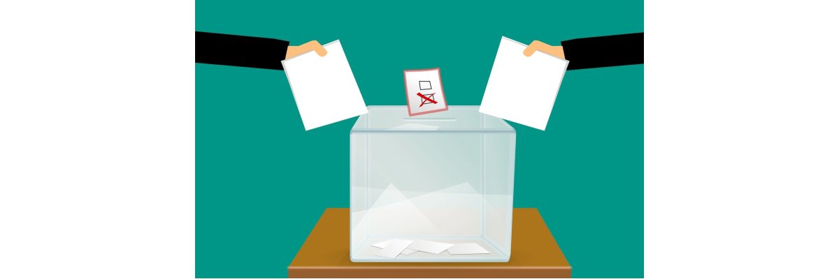 Wahlurne mit Stimmzetteln Viereckige Wahlurne mit darüber rechts und links ein Arm mit Stimmzetteln und ein Stimmzettel mit einem Kreuz in der Mitte über der Urne