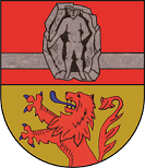 In geteiltem Schild oben in Rot ein erniedrigter silberner Balken belegt mit einer silbernen Figur mit schwarzem Hintergrund, die Merkur darstellt, auf silbernem Stein; unten in Gold ein wachsender blaubewehrter und –gezungter Löwe.  