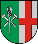 Schild gespalten; vorne in Grün vor zwei gekreuzten silbernen Hämmern eine silberne Ähre, hinten in Silber ein rotes Kreuz.