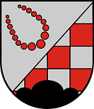 Schild schräglinks geteilt, vorne in Silber eine nach oben geöffnete Kette mit roten Klicker-Steinen, hinten rot-silber geschacht, belegt mit einem schwarzen Dreiberg.