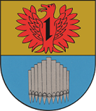 In geteiltem Schild oben in Gold ein rotes Fabeltier mit einem Wolfskopf und weit geöffneten Schwingen belegt mit einem schwarzen Wolfshaken, unten in Blau elf silberne Orgelpfeifen.